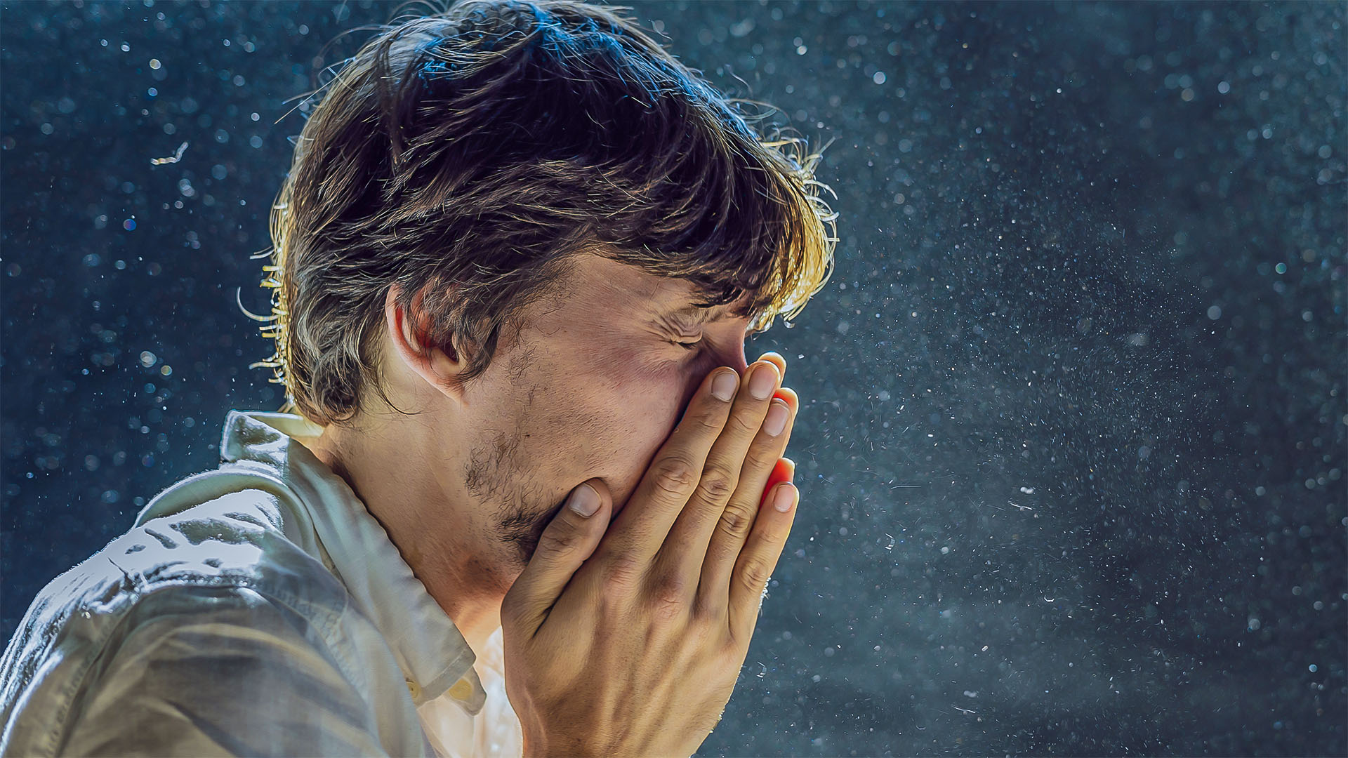 man coughing in dust cloud