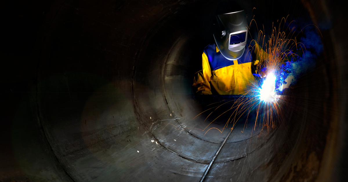 Industrial Worker Welding Metal in Confined Space