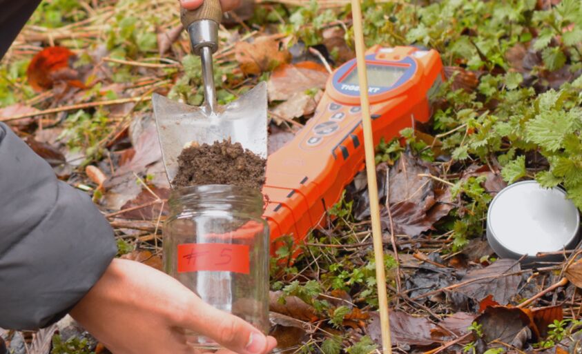 Person taking soil samples and using TIger XT VOC detector